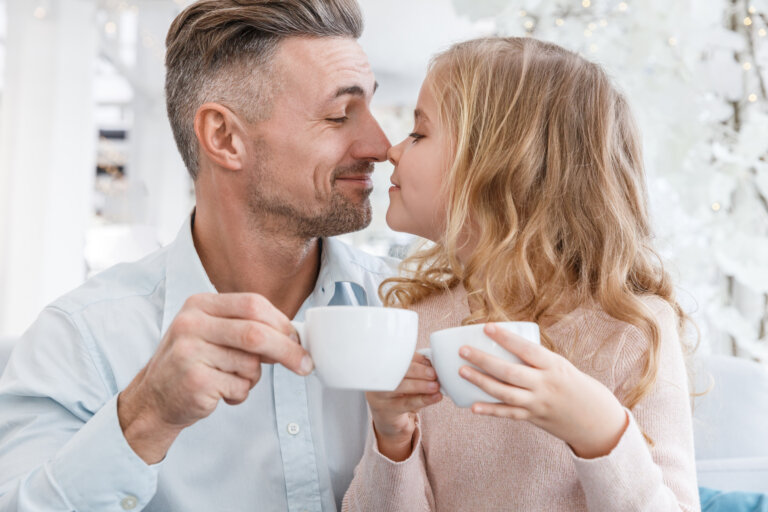 Happy Father and Daughter Clinking Teacups and Enjoying the Benedits of Tea